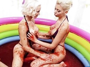 Two naughty blondes enjoy playing into the jelly bath and have lesbian fun
