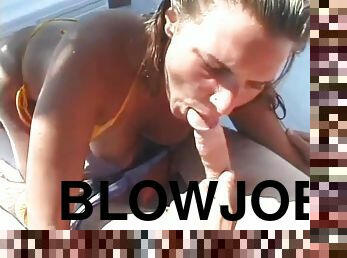 Bikini girl sucks off a guy on a boat