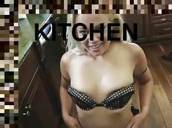 Kenzi grin bends over the kitchen sink