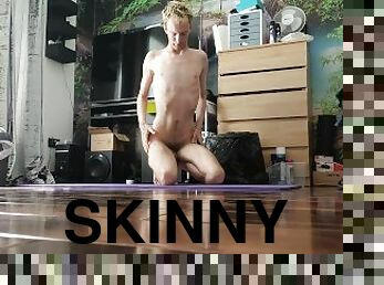Very skinny lad stretches out his body on a yoga mat