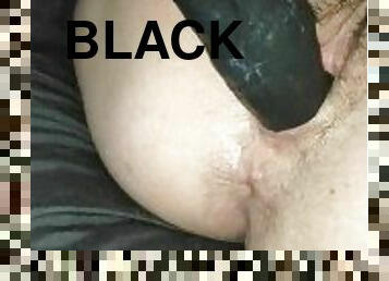 Fucking a huge black dildo