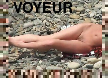 Voyeur enjoying nude babes at the beach
