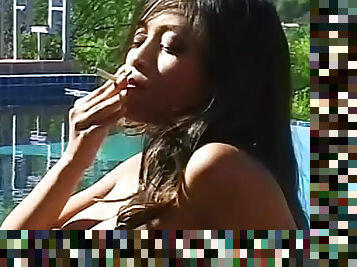 Smoking girl shows her big tits outdoors