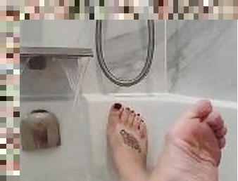 Beautiful wet feet in the bath