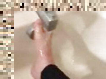 Alexis Black rubs her feet in the bath with leggings