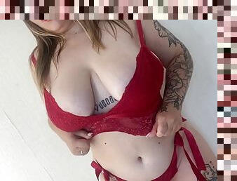 Plus size model in red lingerie, gentle striptease and touching herself with oil
