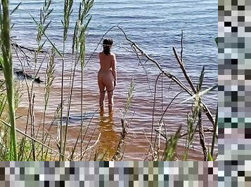 Spy sexy nudist girl on a wild beach