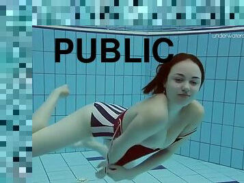 Elegant lada takes off a swimsuit to show her nude body underwater