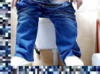 Hot MILF in jeans pissing in a public restroom