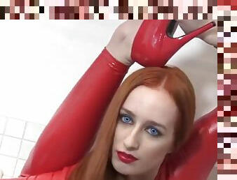 Flexible woman in red latex catsuit, redhead