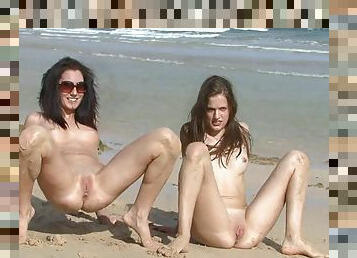 two naked chicks on the beach