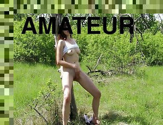 Flirtatious 18-years-old dark haired lady fingers herself by a tree