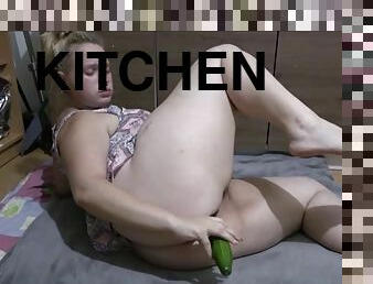 Big ass girl masturbates with cucumber in the kitchen