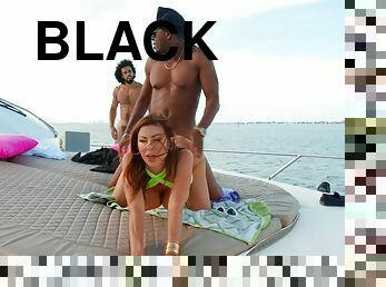 Alexis Fawx pleasures two horny black studs on a boat