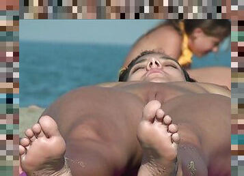 Seductive brunette teen tanning naked on the beach