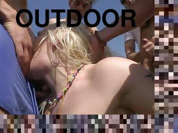 Pale blonde bitch sucks a ton of cocks outdoors