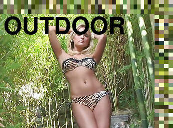 Cute blonde Traci Denee poses in the green forest
