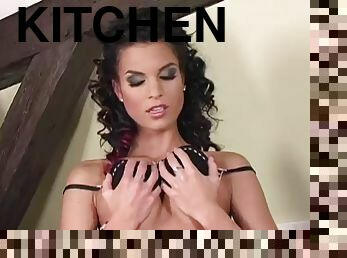 Sexy brunette masturbates with a big dildo on the kitchen counter