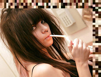 Teen girl smokes while stripping