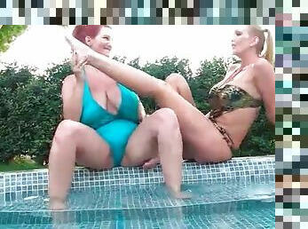 Curvy women in swimsuits suck on their toes