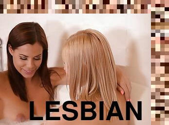 Lesbian cuties have some fun in the bathtub while washing