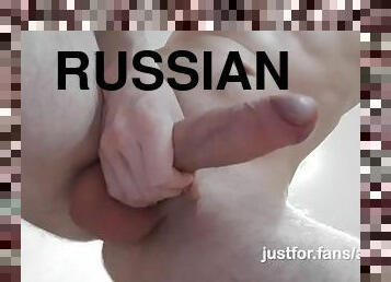 Russian guy jerks off his cock and cums on the floor