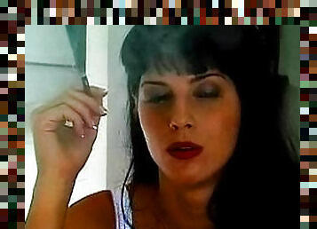 Girl in a white corset smokes cigarette