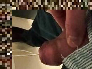 Man unzips his pants pissing in office toilet and shows his wet cock close to camera