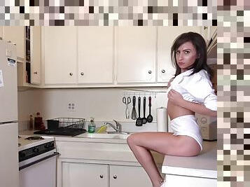 Nude teen fingers her shaved pussy in the kitchen