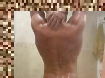 Young muscular stud giving some ass play while showering