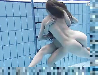 Enjoying underwater lesbian sex with a redhead