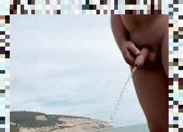 Risky piss on public beach naked